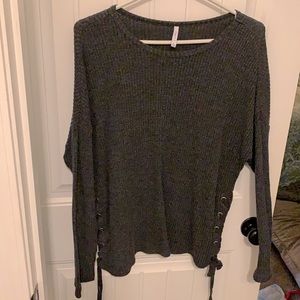 Long-sleeved charcoal shirt with ties on the side.